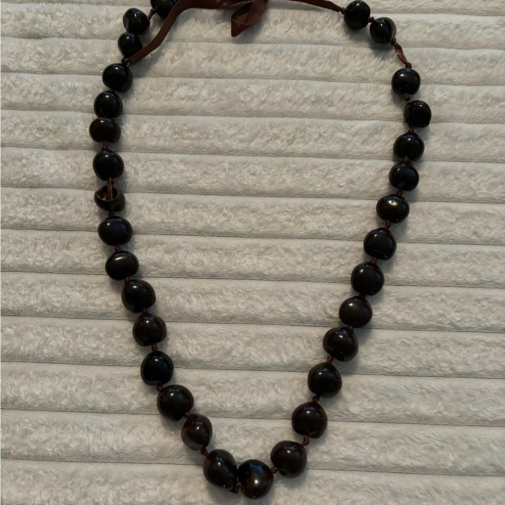 Traditional Hawaiian dark brown KuKui nut necklace.